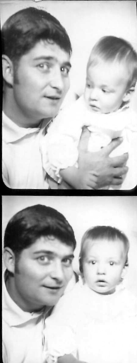 Two-frame black-and-white photo strip showing a man with dark hair holding a baby in a white outfit; in the top frame they both face the camera, in the bottom frame the baby looks toward the camera while the man leans in close to the child (vintage style).