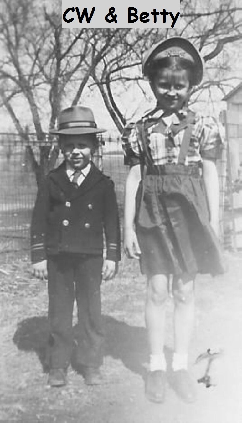 Two children outdoors in vintage clothing, a boy in a suit and hat and a girl in a plaid dress and large hat, with 'CW & Betty' text at the top.