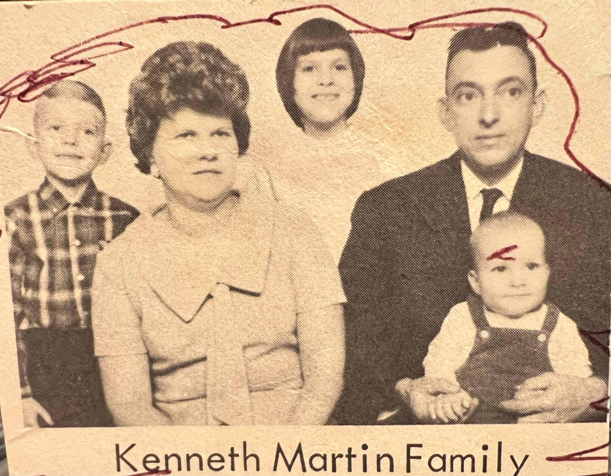 Family portrait of the Kenneth Martin family: two adults and two children posed together, clipping style photo in a newspaper
