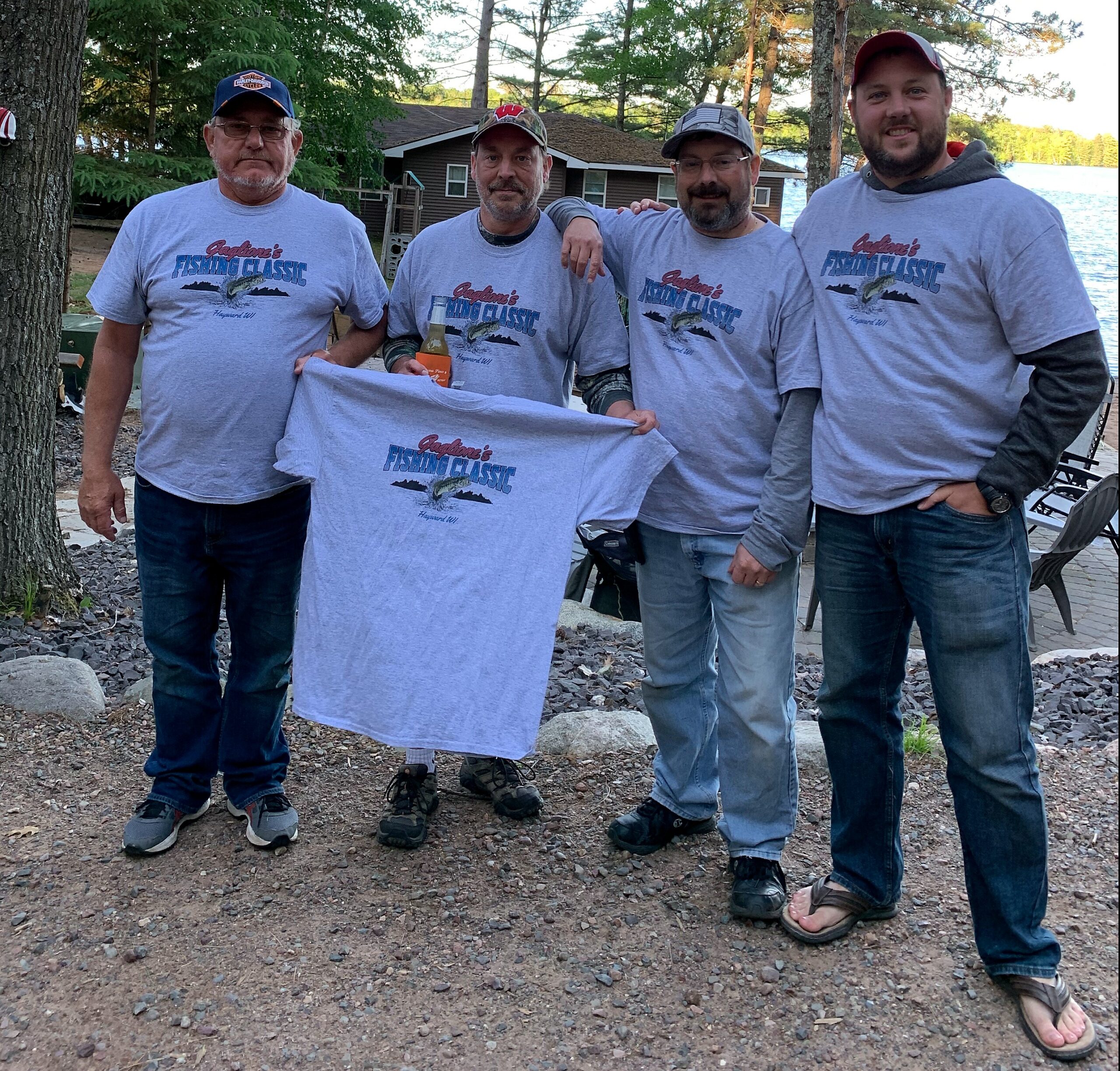 Four men wearing matching gray 
