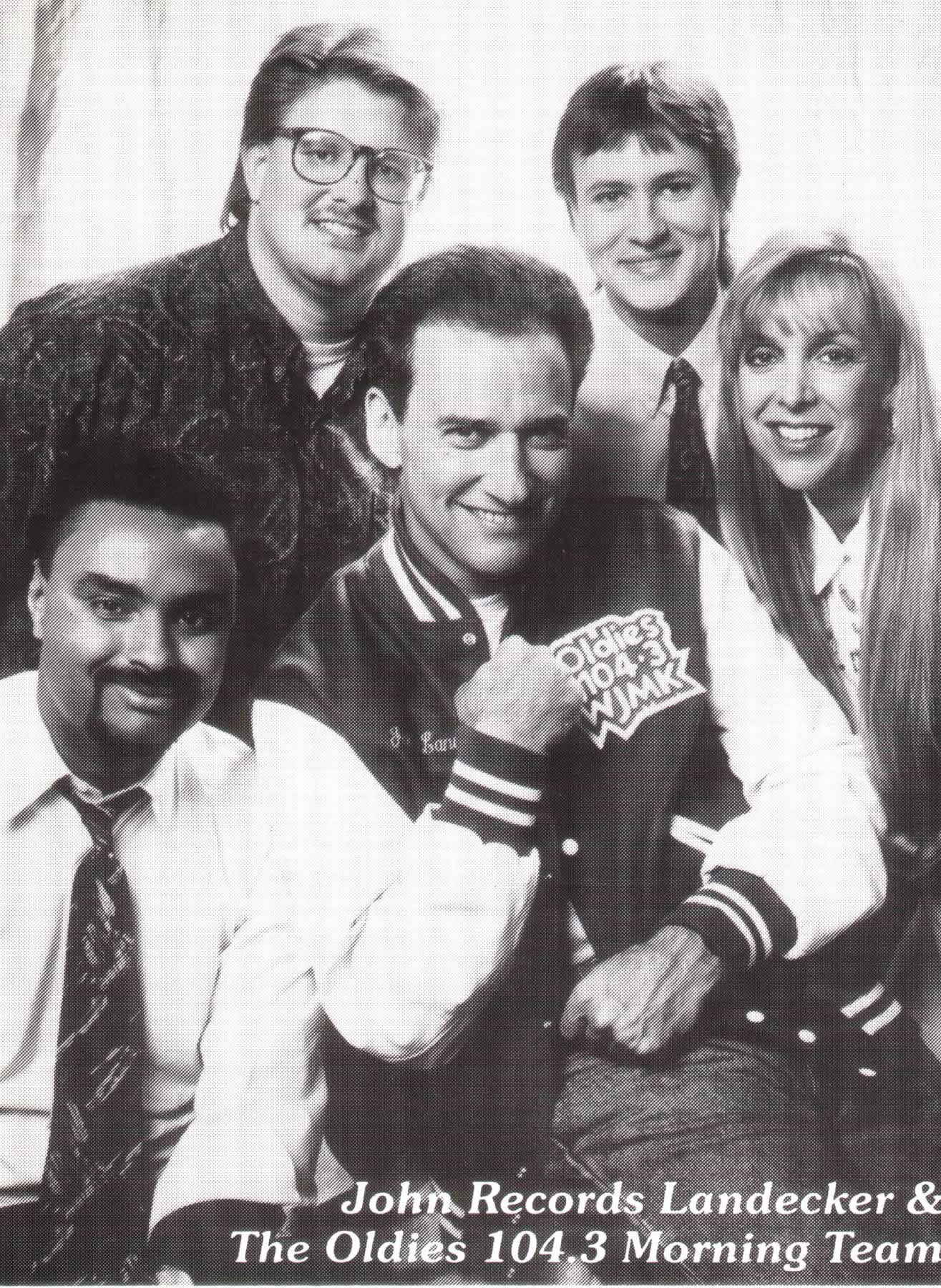 Group photo of five smiling radio show hosts, The Oldies 104.3 Morning Team.
