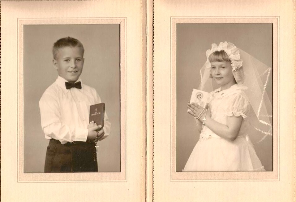 Two vintage portraits in a scrapbook: a boy in a white shirt and bow tie holding a small book, and a girl in a lace dress with a veil holding a keepsake.