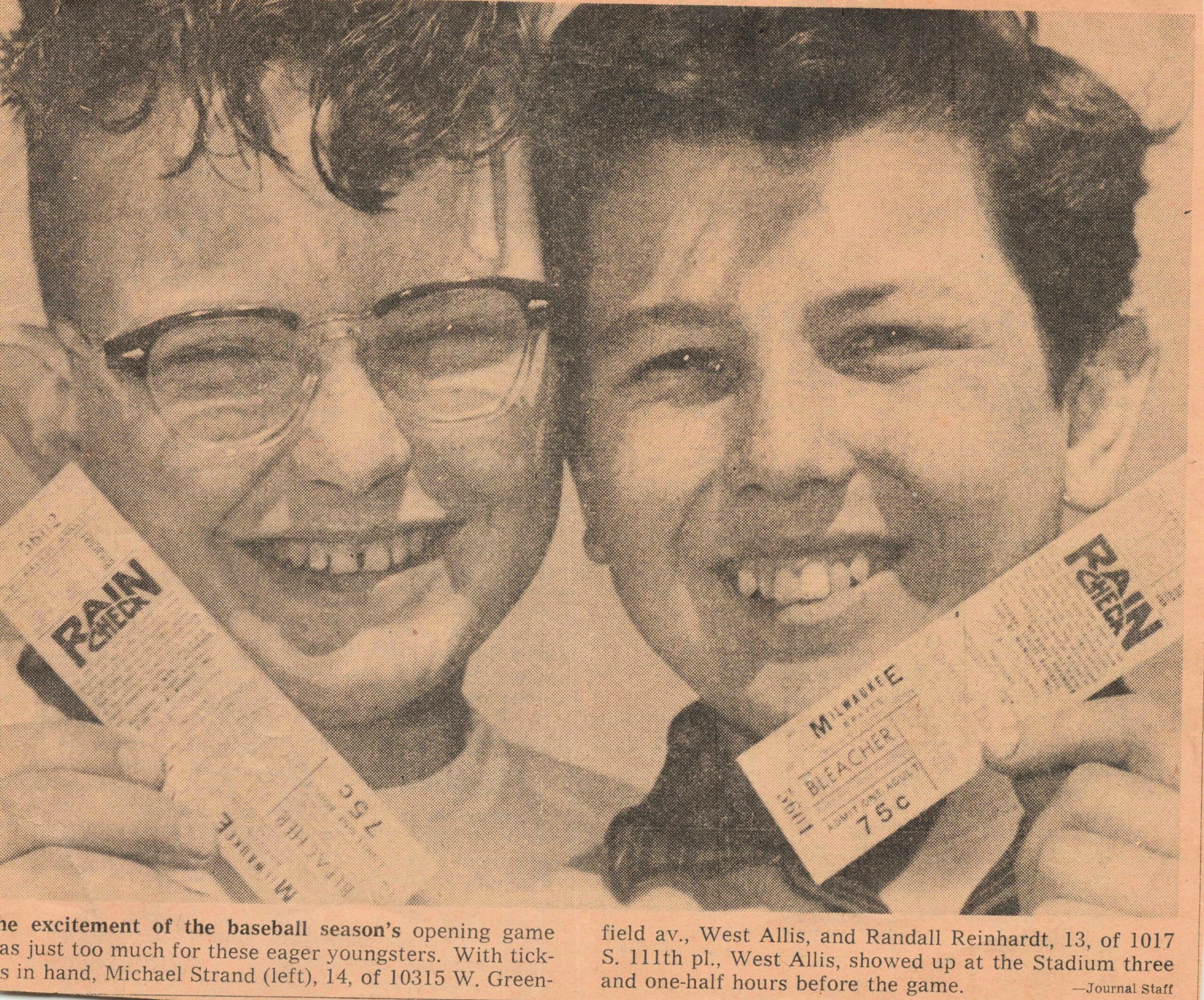 Two men smiling in a close-up newspaper photo, one wearing glasses, with baseball ticket stubs and article text around them.