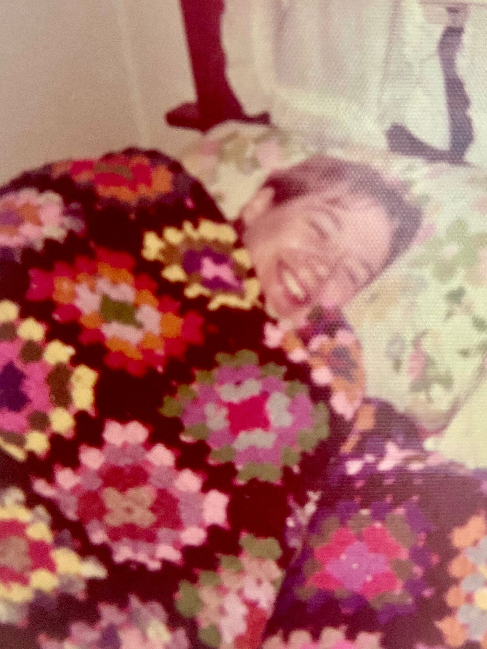 Close-up of a multicolored floral mosaic pattern on fabric.