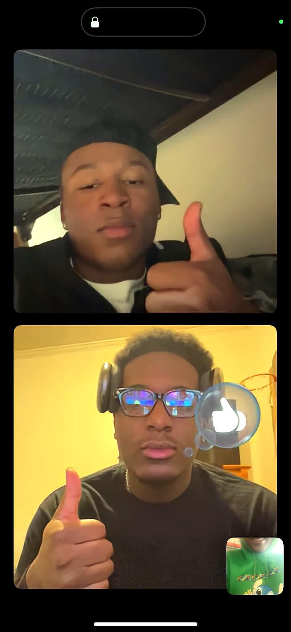 Two young men on a split-screen video call giving thumbs-up; top person wears a cap, bottom person wears glasses and headphones.