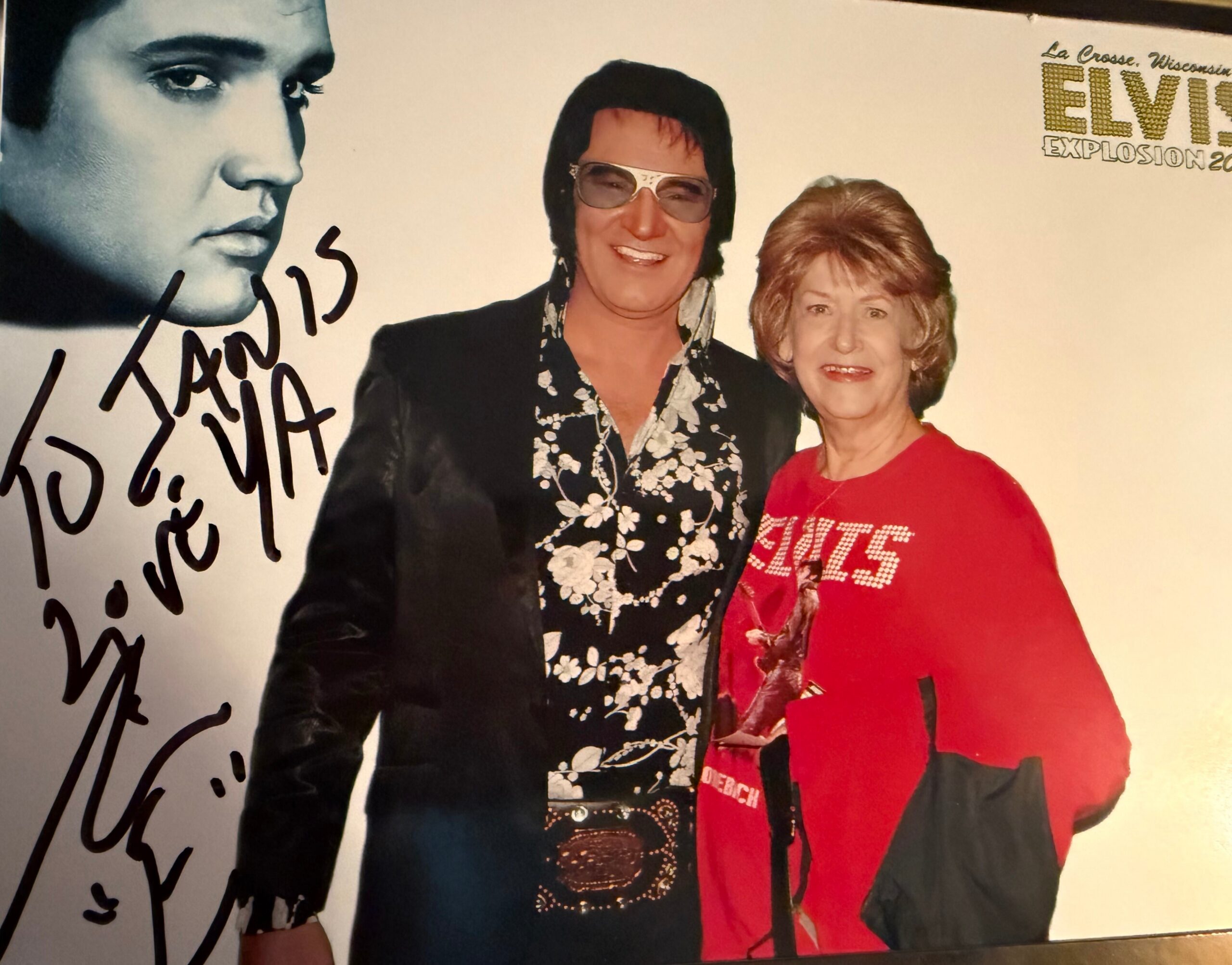 Collage-style poster with a large blue-tinted Elvis portrait on the left and two people, one in glasses and a patterned shirt, another in a red shirt, standing together on the right, with Elvis text in the corner.