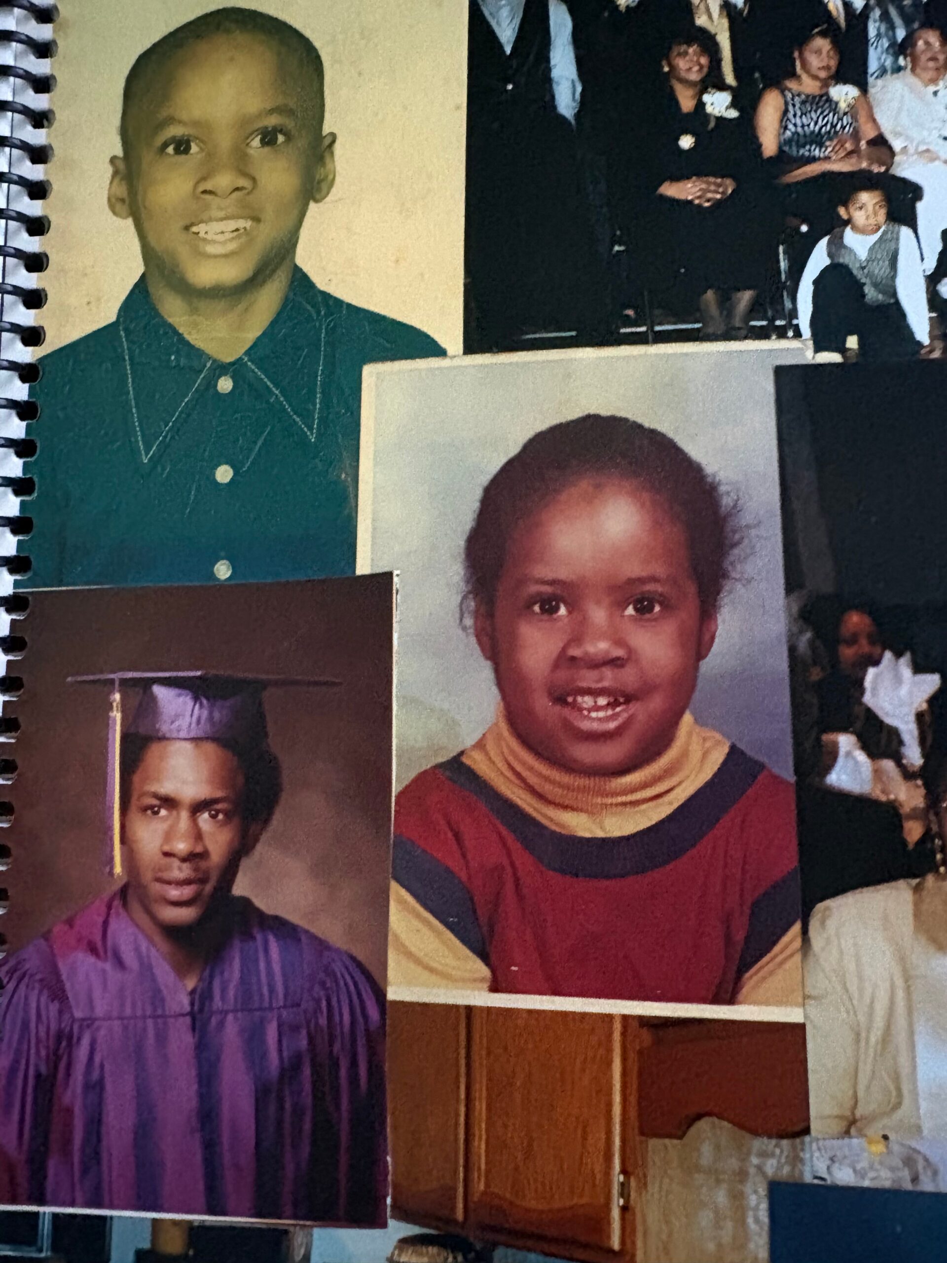 A collage of student portraits on a wall, with a smiling boy in a teal shirt at top left and a girl in a striped sweater toward the center right.