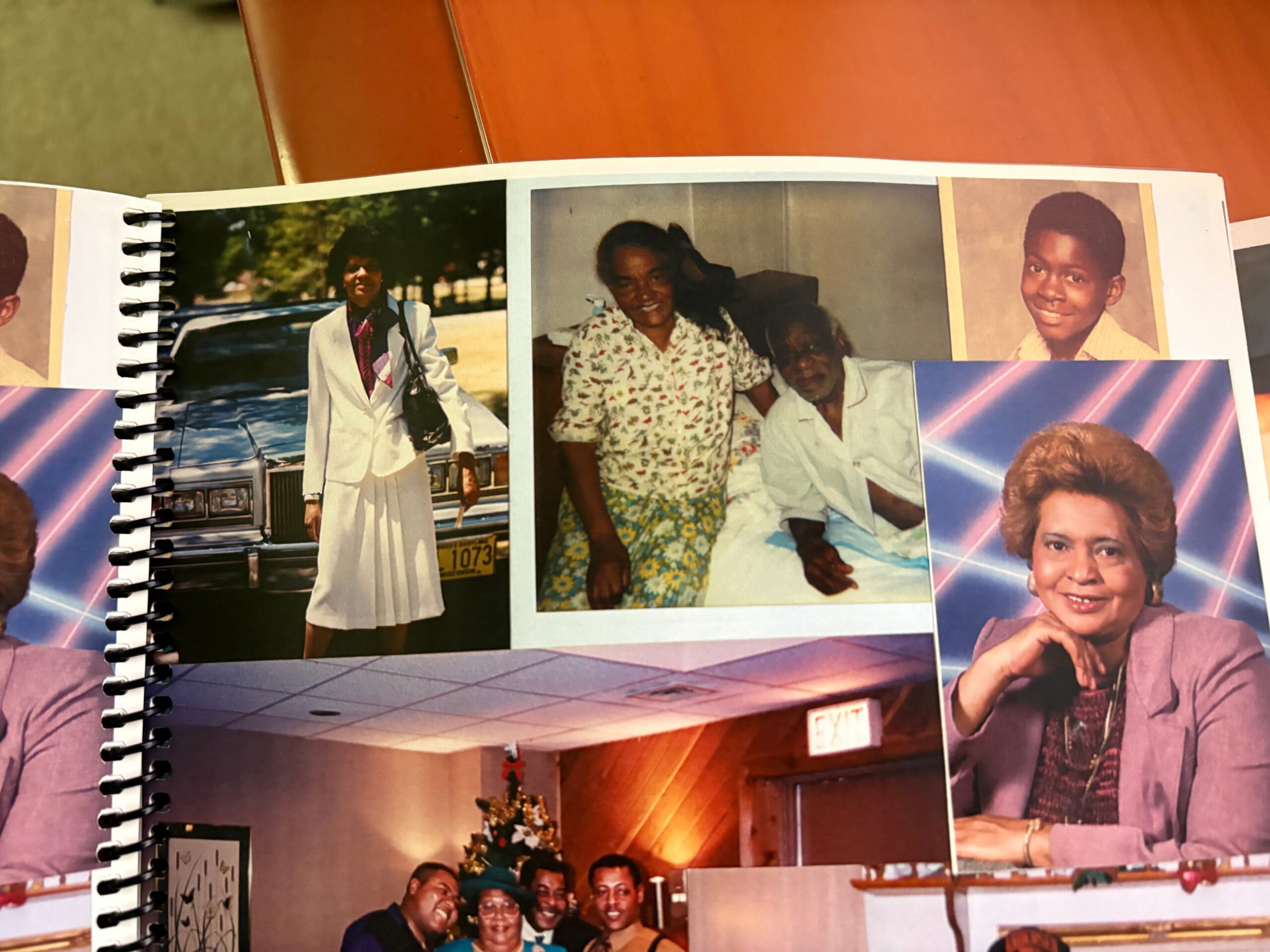 Open spiral-bound photo album showing multiple vintage pictures arranged on a page.
