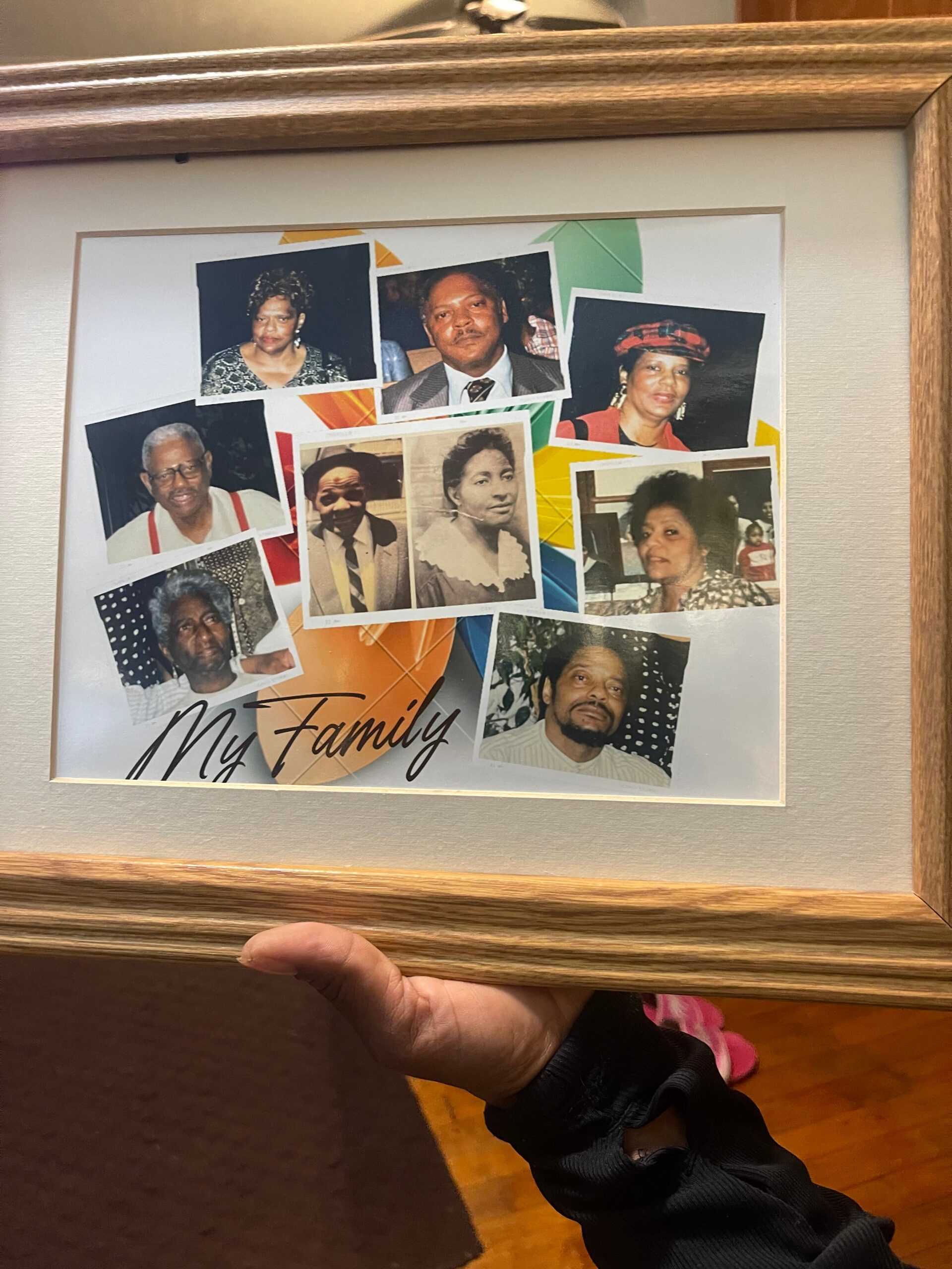 Framed collage titled 'My Family' with multiple individual portrait photos of relatives arranged on a colorful geometric background.