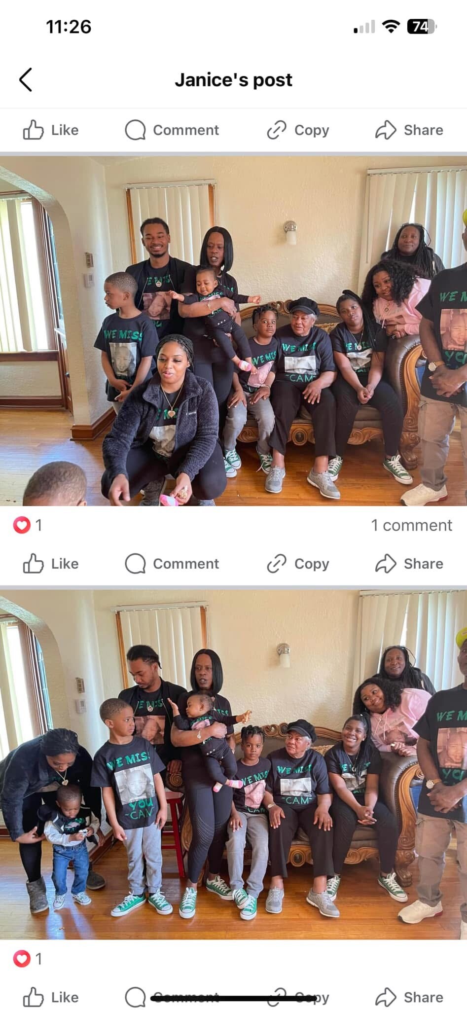 Group of family members posing for a photo in a living room, wearing matching black shirts that say 'We miss you.'
