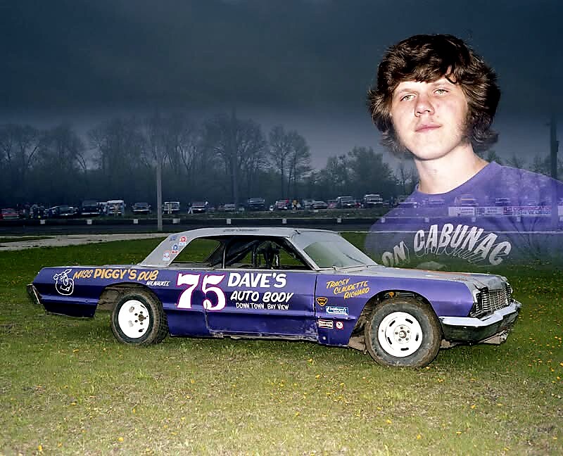 Purple #75 race car with Dave's Auto Body decals on a grassy field; ghosted portrait of a young man overlays the scene.