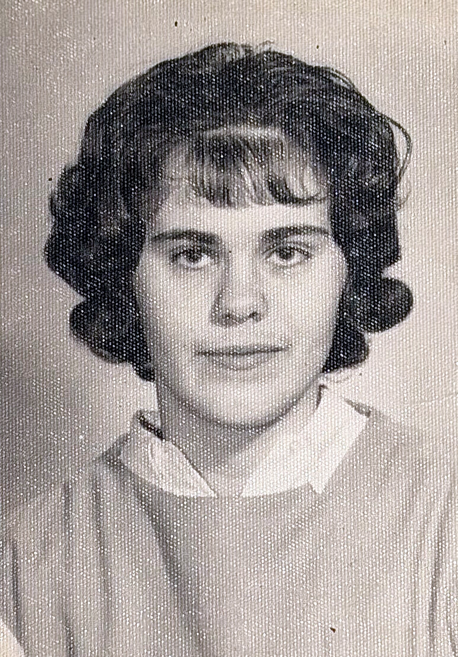 Black-and-white head-and-shoulders portrait of a smiling woman with short, wavy hair wearing a collared blouse.